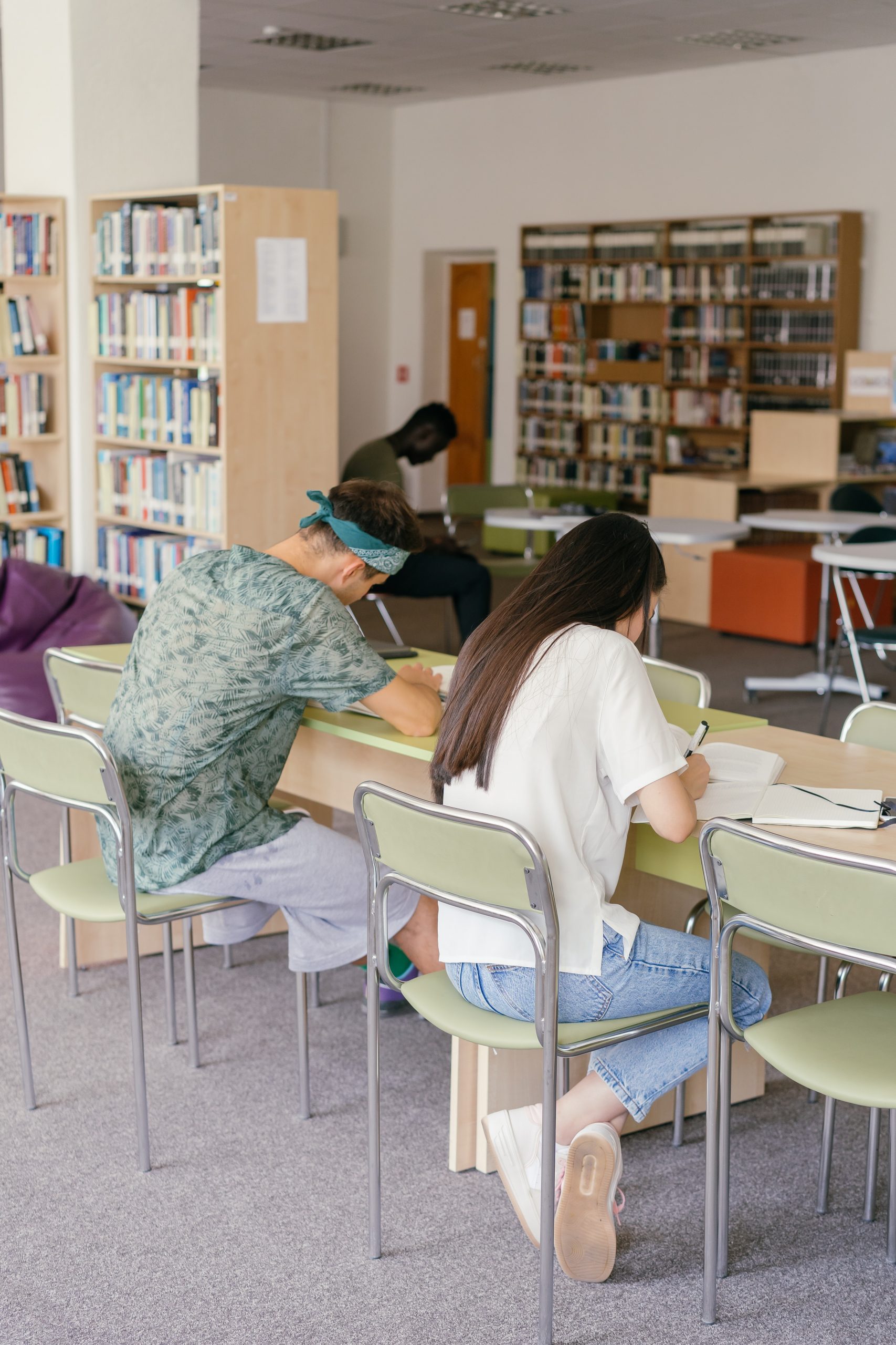 Photo by Mikhail Nilov: https://www.pexels.com/photo/a-man-and-woman-writing-on-the-table-inside-the-library-9158767/